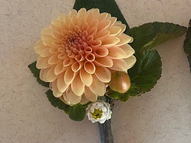 Two floral hairpins with pink and yellow flowers on a light background