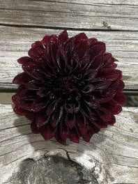 Dark purple flower on a wooden surface